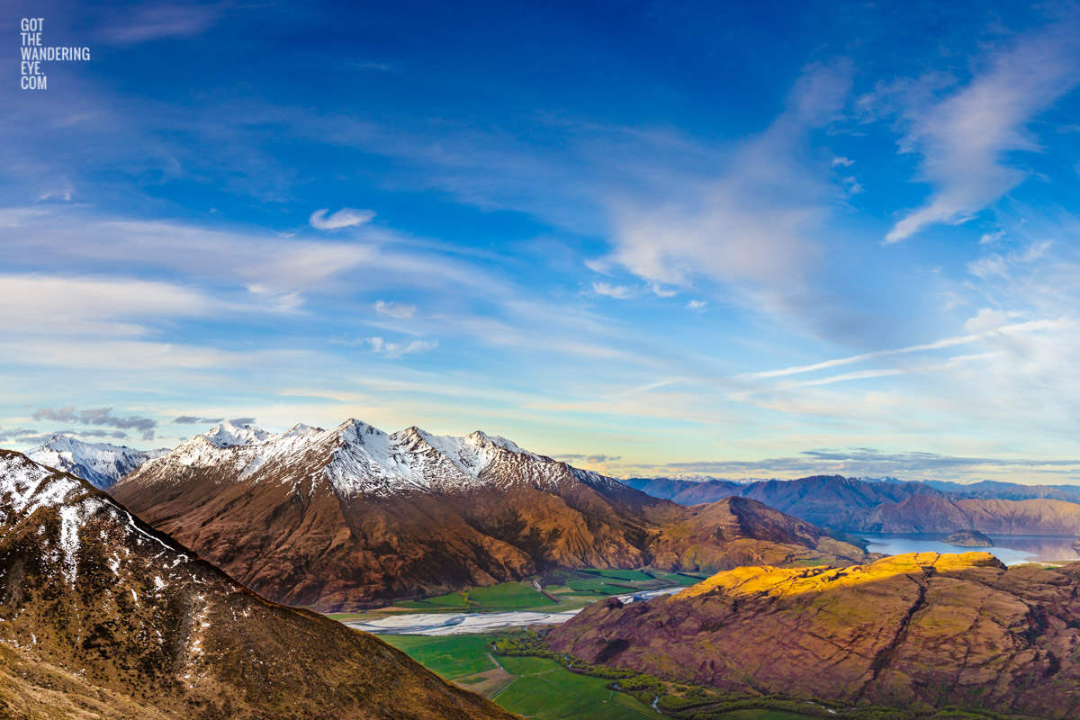 The most spectacular view down from the top of Treble Cone Road over Rocky Mountains to Lake Wanaka, New Zealand
