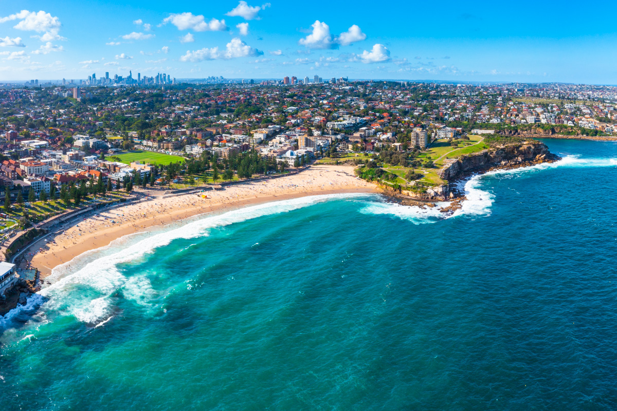 Coogee Beach Aerial Print. Postcard view above Coogee Beach looking back towards Sydney Skyline.